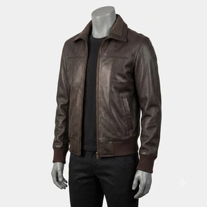 A dark brown leather jacket displayed on a gray mannequin torso, worn over a black shirt and black pants against a light gray studio background.